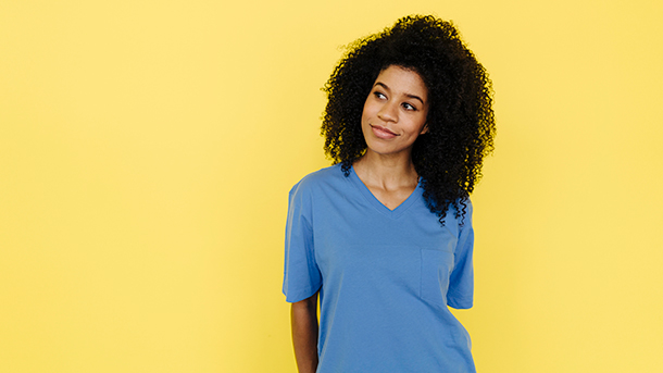 Woman in blue shirt on a yellow background